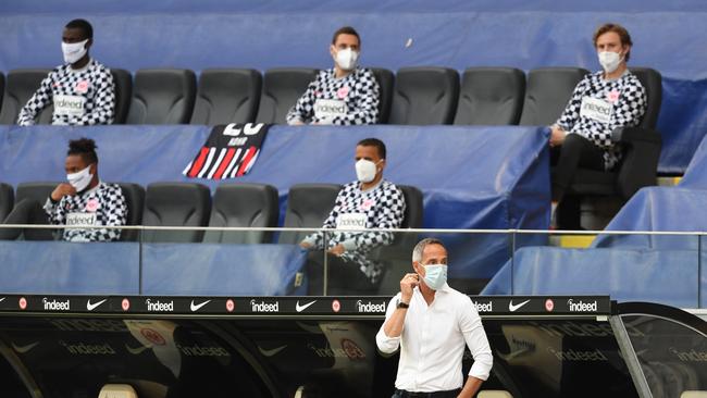 Coaches and substitutes wear masks during a Bundesliga game between Eintracht Frankfurt and Sport-Club Freiburg this week