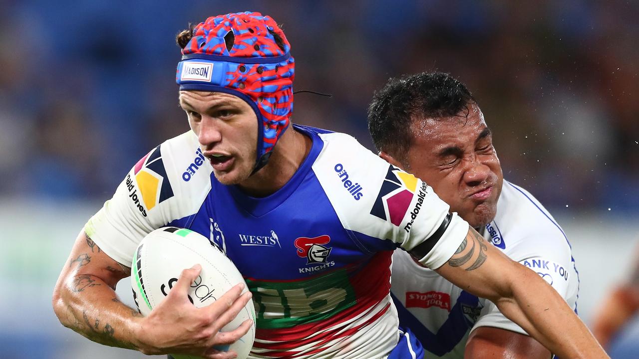 GOLD COAST, AUSTRALIA - AUGUST 21: Kalyn Ponga of the Knights is tackled during the round 23 NRL match between the Canterbury Bulldogs and the Newcastle Knights at Cbus Super Stadium, on August 21, 2021, in Gold Coast, Australia. (Photo by Chris Hyde/Getty Images)