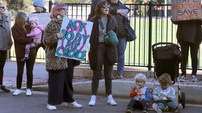 Three-year-old cousins Oliver and Harry enjoy a snack, unfazed by the protest going on around them. Picture: Dean Martin