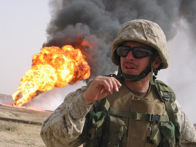 MEU Marine Maj. Jorge Lizarralde is seen at the Rumeila (Rumaila rumayla) oilfield  Mar 29, 2003. Only two wells are still burning, bolstering hopes that oil exports can resume soon. (AP PicBurt/Herman)  Operation Iraqi  Freedom - Iraq War american armed forces o/seas headshot flames smoke pollution air