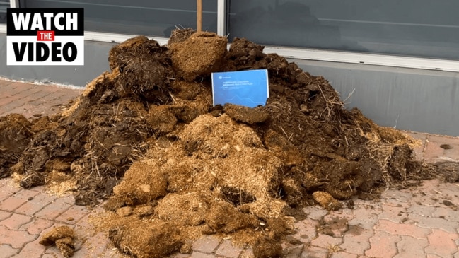 Climate change activists have dumped a pile of horse manure out the front of the Simon Birmingham's South Australian electorate office