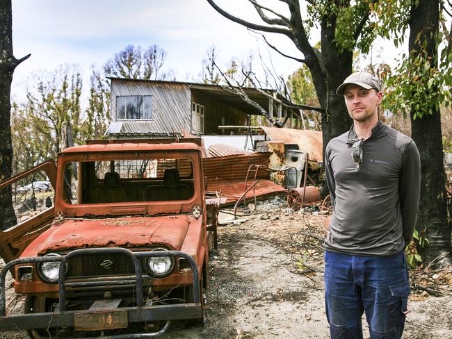 George Brettingham-Moore surveys the damage after bushfire ripped through his parents’ Geeveston property. Picture: AMANDA DUCKER