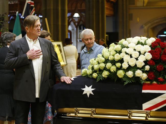 Beautiful roses adorn the coffin. Picture: David Caird