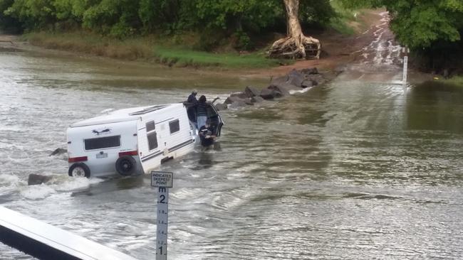 A man and three occupants managed to escape the flooded vehicle with their lives after it was washed off the notorious Cahills Crossing. Picture: John McNeur