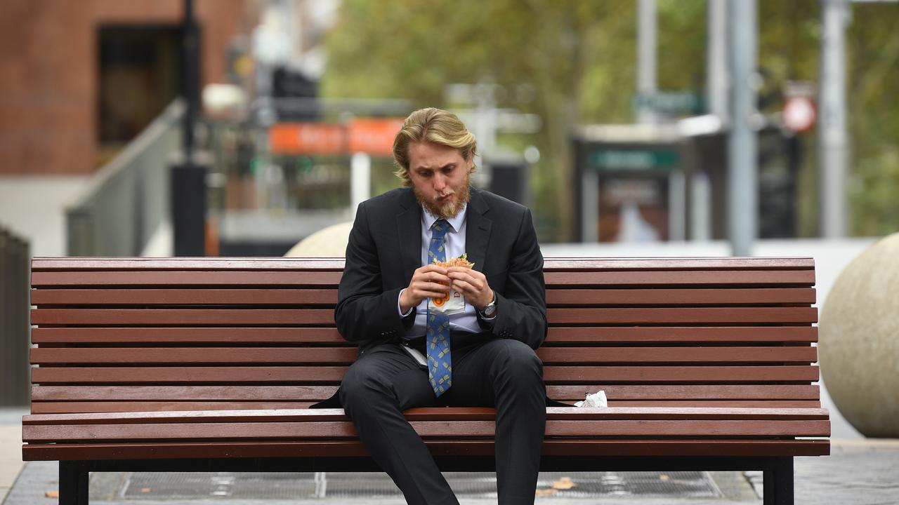 A man eats his lunch alone amid new social distancing policies