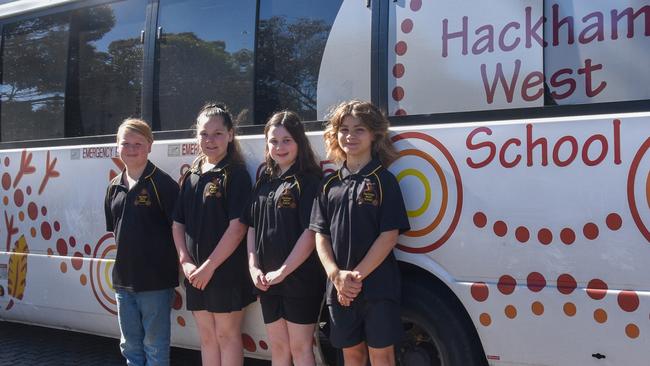 Hackham West Primary School students Theo, 11, Sheniqua, 10, Matilda, 11 and Lucas, 11, with the school's bus. Picture: Supplied