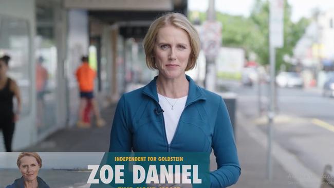 Woman addresses camera in street wearing green blouse