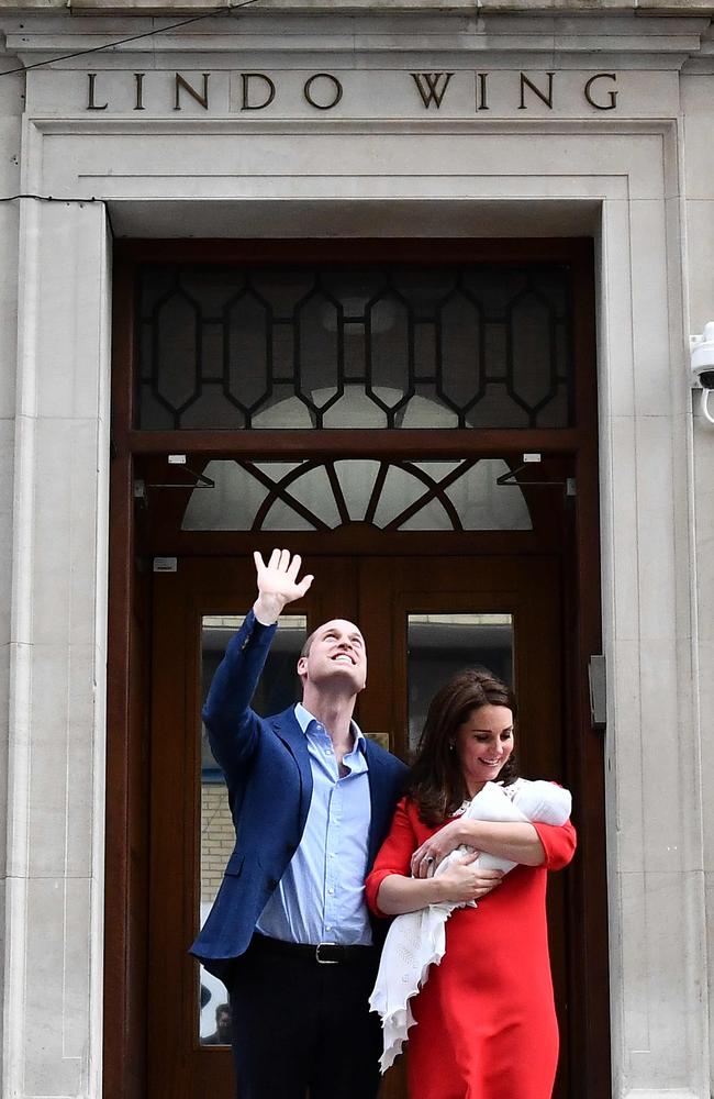 The Duke of Cambridge waves to people watching the special moment from windows above. Picture: AFP Photo / Ben Stansall