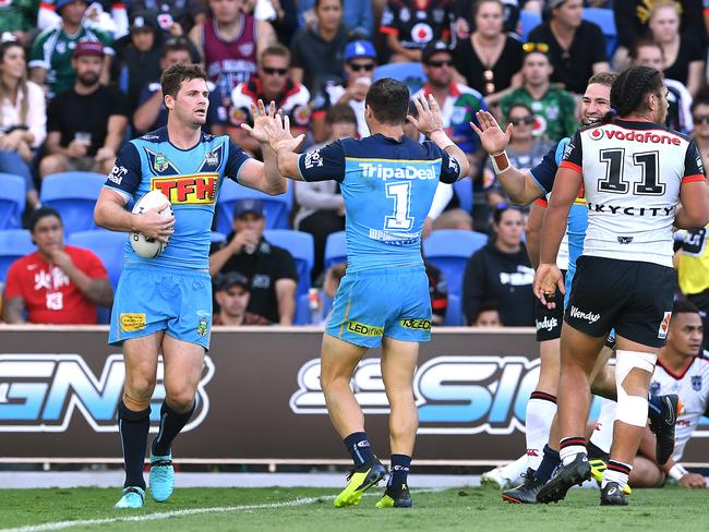 Anthony Don of the Titans (left) reacts after scoring a try during the Round 20 NRL match between the Gold Coast Titans and the Warriors at Cbus Super Stadium on the Gold Coast, Sunday, July 29, 2018. Picture: AAP Image/Dave Hunt.