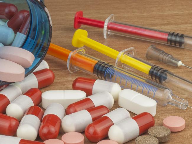 Doping in sport. Abuse of anabolic steroids for sports. Anabolic steroids spilled on a wooden table. Fraud in sports. Pharmaceutical industry. Detailed view of the medication. Place for your text.