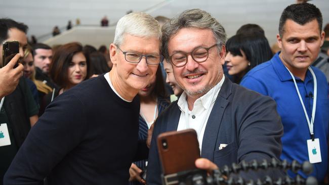 Apple chief executive Tim Cook, left, poses for a selfie with a guest during an Apple product launch at the group’s headquarters in Cupertino, California, a year ago. Apple is expected to unveil is its iPhone 12 models this week. Picture: AFP