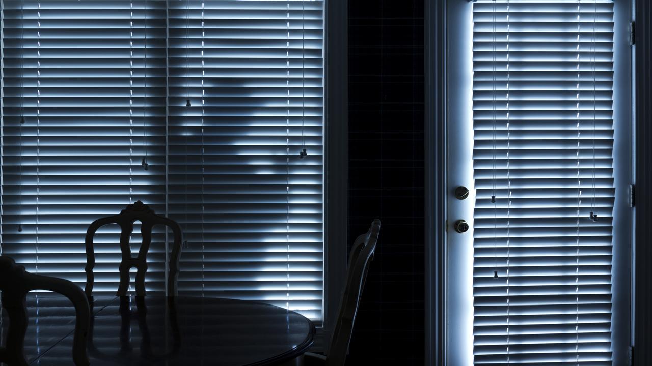 This photo illustrates a silhouette  of a burglar or thief sneaking up to back door at night. View from inside the residence. Picture: ricardoreitmeyer/iStock