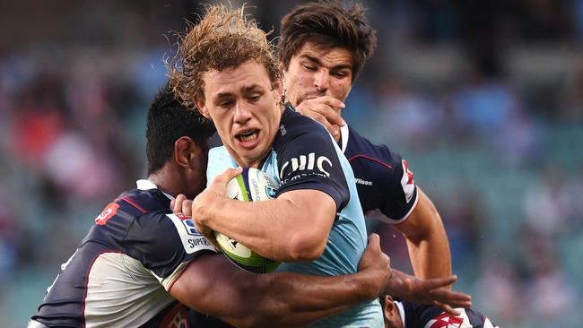 Ned Hanigan (centre)of the Waratahs is tackled by Lopeti Timani (left) and Amanaki Mafi of the Rebels during the Round 13 Super Rugby match between the NSW Waratahs and the Melbourne Rebels at Allianz Stadium in Sydney, Sunday, May 21, 2017. (AAP Image/Paul Miller) NO ARCHIVING, EDITORIAL USE ONLY