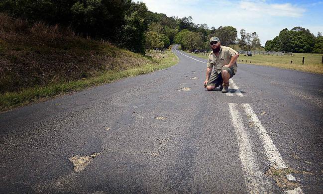 SORRY STATE: Peter Szaak of Booerie Creek is concerned about the condition of Nimbin Rd in front of his house, where there have been eight accidents in six months. Picture: Cathy Adams