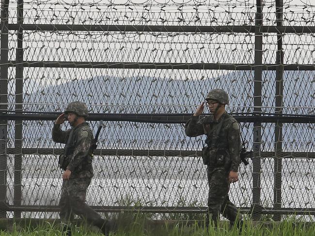 South Korean army soldiers patrol along the barbed-wire fence in Paju, near the border with North Korea as the nation offered talks with its neighbour in a bid to ease animosities. Picture: Ahn Young-joon/AP