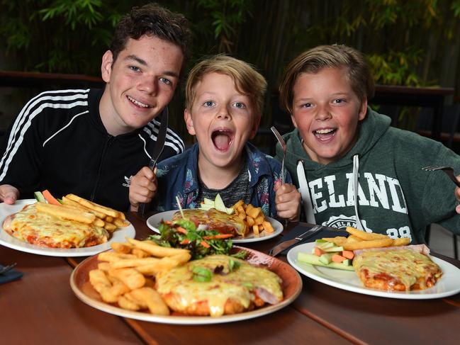 Elliott, Jacob and Oliver ready to eat their parmas. Picture: Josie Hayden