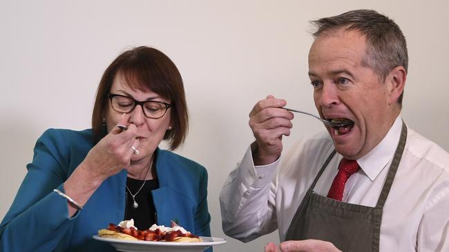 Australian Opposition Leader Bill Shorten and Labor MP Susan Templeman eat strawberry pancakes at Parliament House, to encourage Australians to support the industry. (Picture: Lukas Coch/AAP)