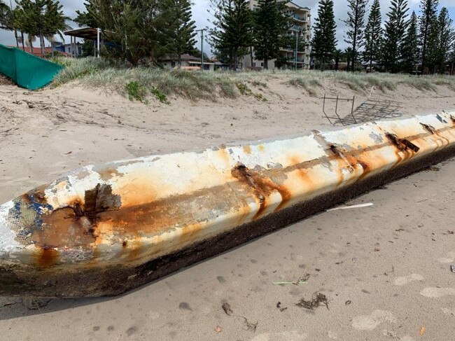 A large piece of the house boat on the sand at Biggera Waters.