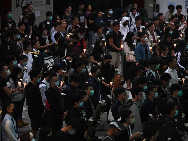 People participate in a vigil at the Hong Kong University of Science and Technology for student Alex Chow, 22. Picture: AFP