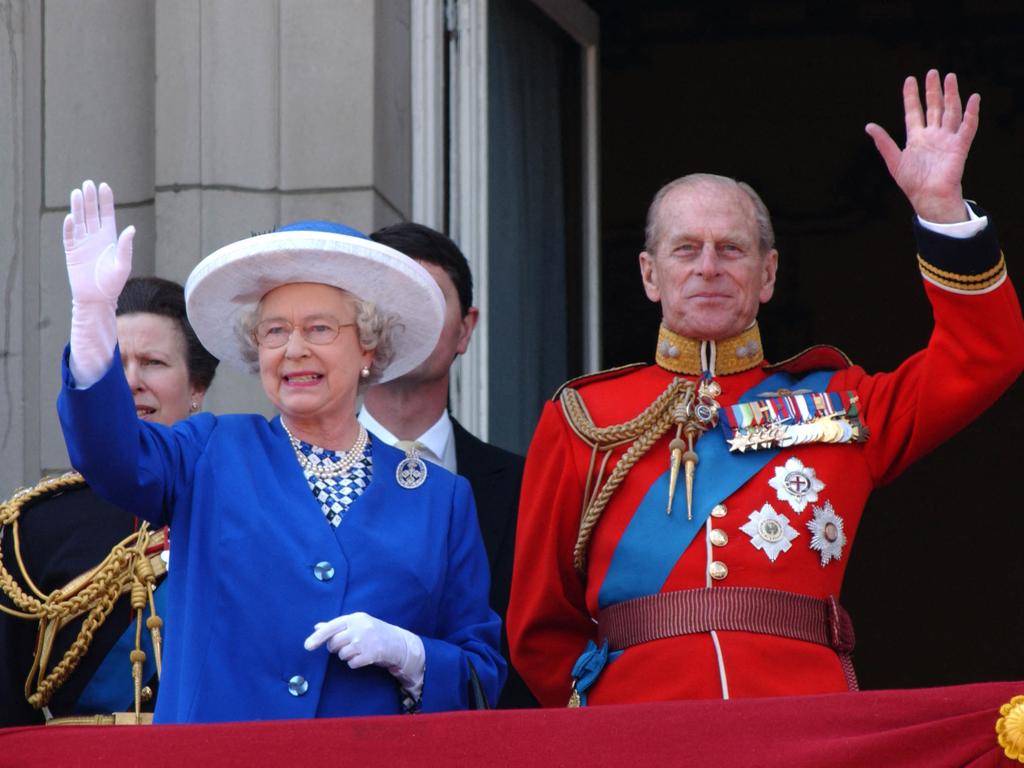 2003: Britain's Queen Elizabeth II (L) and Britain's Prince Philip, Duke of Edinburgh (R) wave from the balcony of Buckingham Palace in London, during a fly-past for the trooping of the colour. Picture: GEOFF GARRATT / AFP