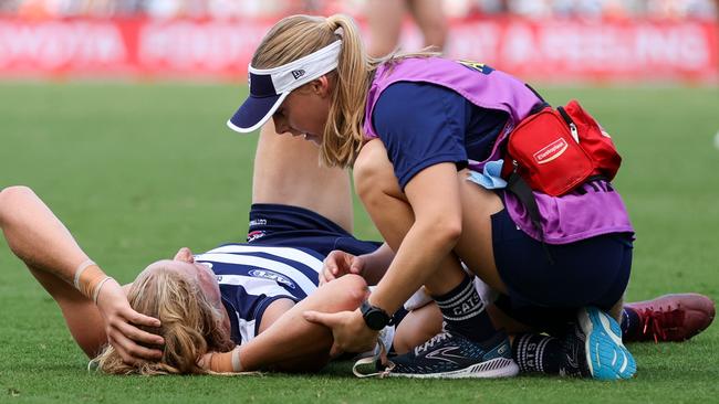 GOLD COAST, AUSTRALIA - APRIL 02: Sam De Koning is assisted by trainers during the 2023 AFL Round 03 match between the Gold Coast Suns and the Geelong Cats at Heritage Bank Stadium on April 2, 2023 in the Gold Coast, Australia. (Photo by Russell Freeman/AFL Photos via Getty Images)