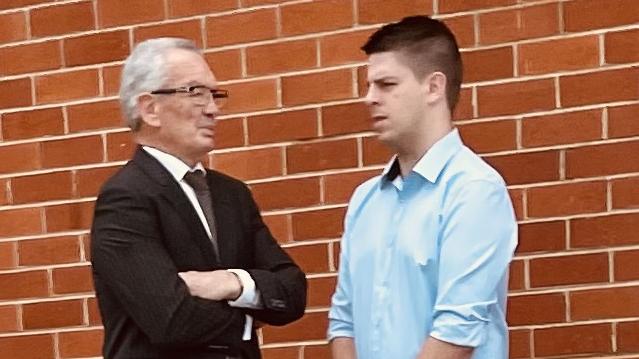 Brenten Simon Zessin (at right) speaking with his lawyer after his court appearance on Tuesday, November 21.