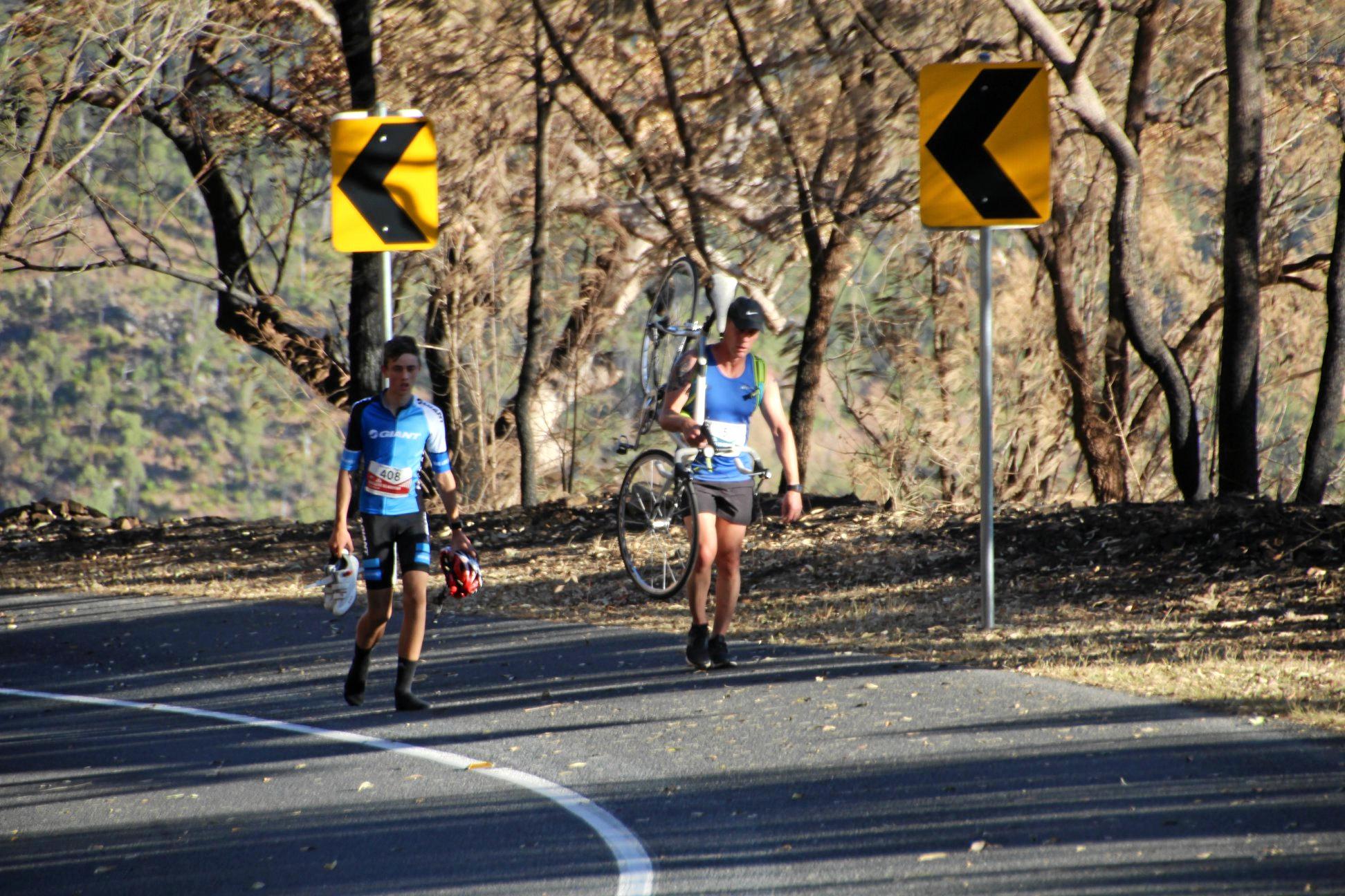 Runner Lee Pratt stops to help a cyclist finish Challenge the Mountain. Picture: Rockhampton Photography Club