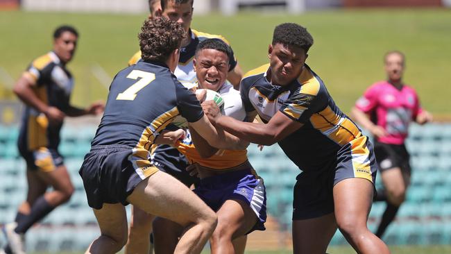 Patrician Brothers Blacktown player Sione Lino runs into the might of the Westfields Sports High defence. Pic: Richard Dobson