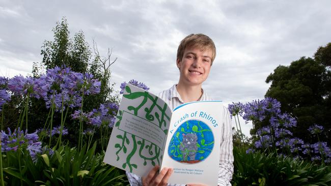 Keagan Wallace with his book, 'A Crash of Rhinos'. He also travelled to Indonesian where he assisted in surgeries. Picture: Brett Hartwig