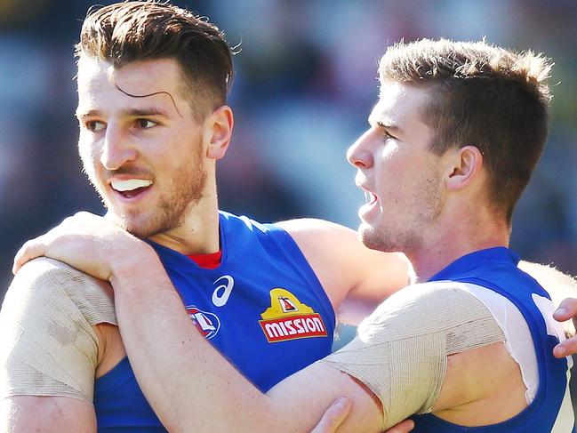 MELBOURNE, AUSTRALIA - AUGUST 25: Marcus Bontempelli of the Bulldogs (L) and Billy Gowers celebrate a goal during the round 23 AFL match between the Richmond Tigers and the Western Bulldogs at Melbourne Cricket Ground on August 25, 2018 in Melbourne, Australia.  (Photo by Michael Dodge/Getty Images)