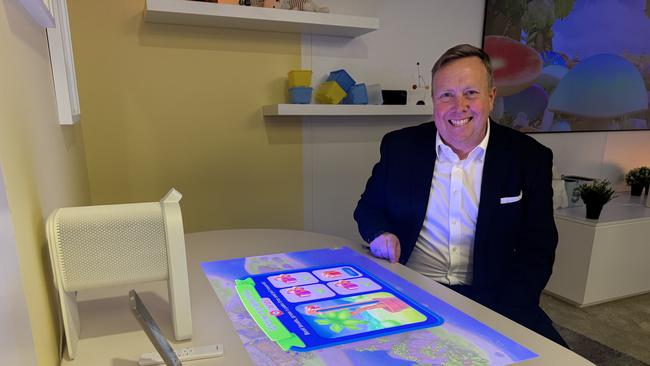 Samsung Australia vice president Jeremy Senior with the Premier 5 touch screen projector, which can project up to 100 inches on flat services such as tables and walls.