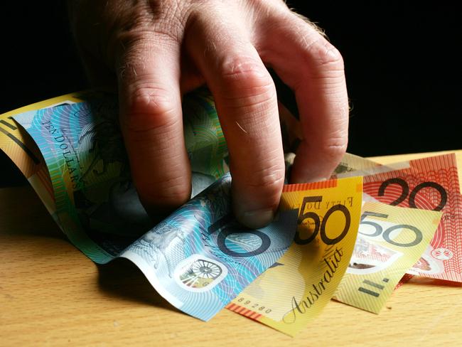 Money Grab. Man's hand. Australian currency. Dollar notes. Grabbing.