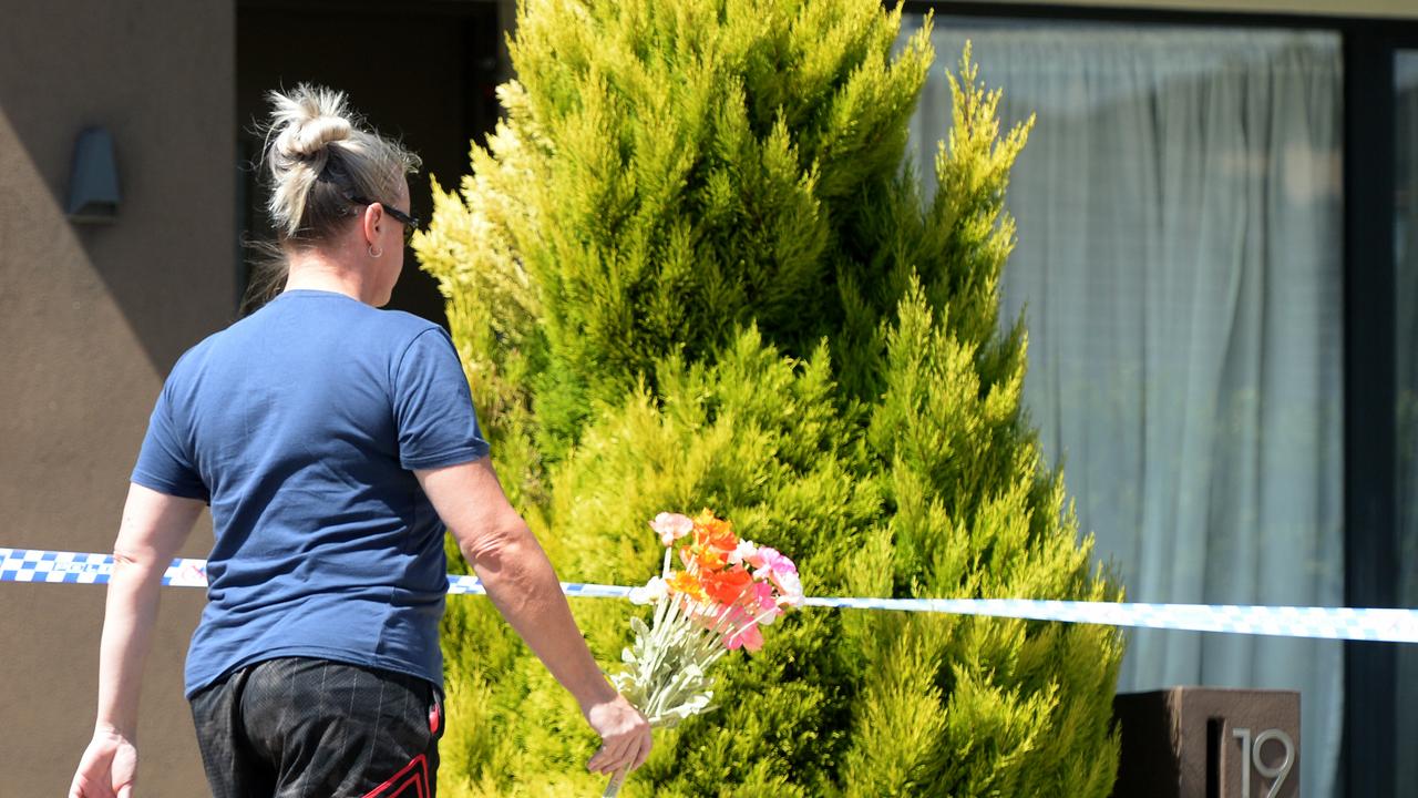 A well-wisher places flowers outside the Point Cook home following the shocking discovery. Picture: NCA NewsWire / Andrew Henshaw