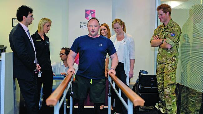 Dr Munjed Al Muderis with a patient with bionic legs, and Prince Harry. Picture: supplied