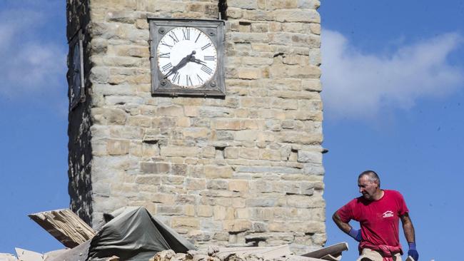 The clock on Amatrice’s 16th century bell tower is frozen at 3.36am, the time Wednesday’s earthquake struck. Picture: Massimo Percossi/ANSA via AP