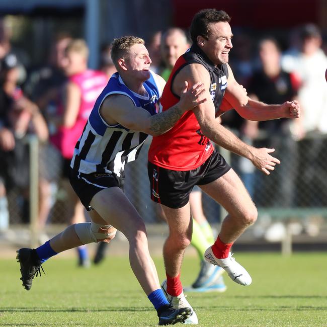 Stawell’s Josh Linton leads Minyip-Murtoa opponent to the ball on Saturday. Picture: Yuri Kouzmin