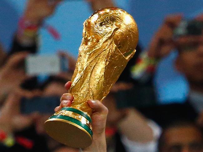 RIO DE JANEIRO, BRAZIL - JULY 13: Manuel Neuer of Germany lifts the World Cup trophy with teammates after defeating Argentina 1-0 in extra time during the 2014 FIFA World Cup Brazil Final match between Germany and Argentina at Maracana on July 13, 2014 in Rio de Janeiro, Brazil. (Photo by Clive Rose/Getty Images)