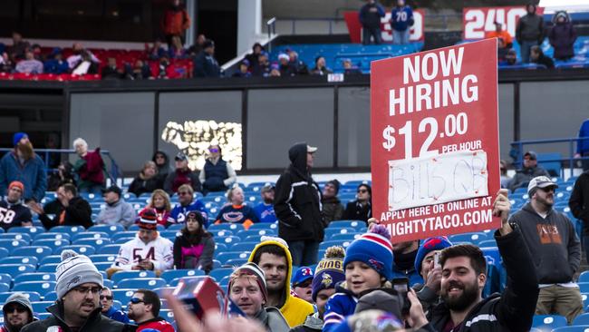 Seeing the funny side.... Buffalo Bills finds hold a sign advertising for a new quarterback during their heavy loss to Chicago. Picture: AFP