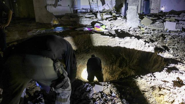 Israel's Home Front Command and police forces look at the damaged site. Picture: AFP