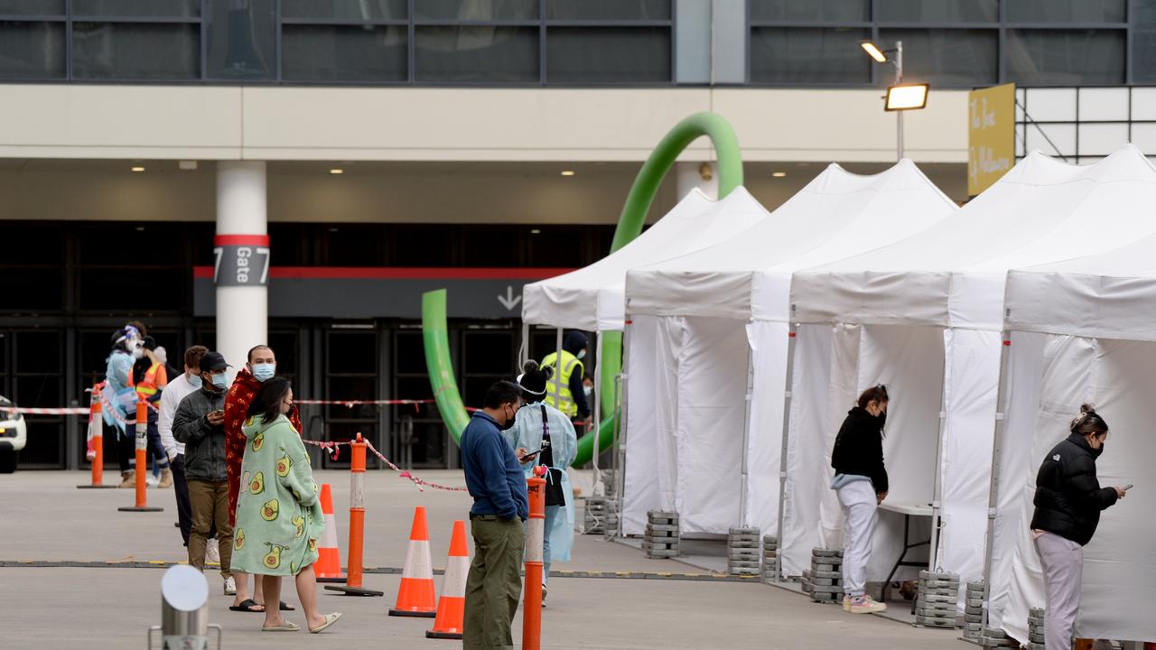 Residents from the Lacrosse apartments queue for COVID tests after their building was listed as an exposure site. Picture: Andrew Henshaw