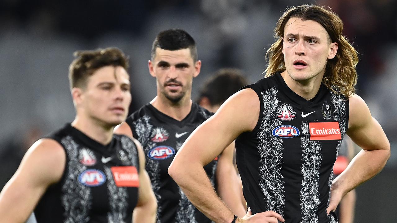 MELBOURNE, AUSTRALIA - APRIL 25: Darcy Moore and his Magpies team mates look dejected after losing the round six AFL match between the Collingwood Magpies and the Essendon Bombers at Melbourne Cricket Ground on April 25, 2021 in Melbourne, Australia. (Photo by Quinn Rooney/Getty Images)