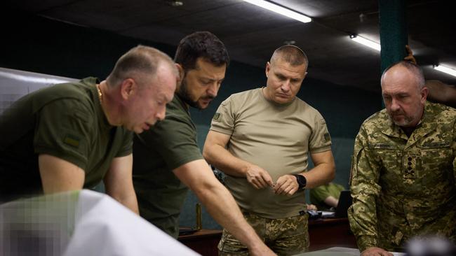 Volodymyr Zelensky (2ndL) and the colonel general Oleksandr Syrskyi (L) visit the brigades engaged in offensive operations in the Bakhmut sector, in Donetsk region. Picture: AFP.