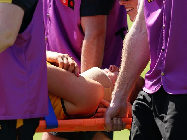 Mackenzie Eardley is taken from the field. Picture: Will Russell/AFL Photos via Getty Images