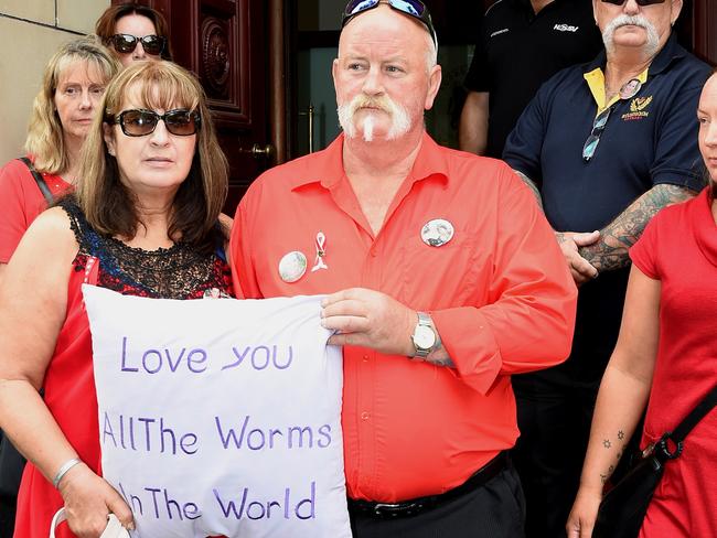 Lynda and Wayne Quinlan (holding cushion) always wore red, their daughter’s favourite colour, to court. Picture: Nicole Garmston