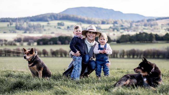 Stephanie Trethewey with her dogs and her children on their Tasmanian farm. Picture: Ness Vanderburgh