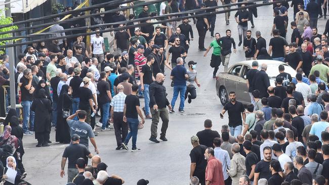 People react after a reported explosion occurred during the funeral of those killed in a pager explosion the previous day. Picture: AFP.