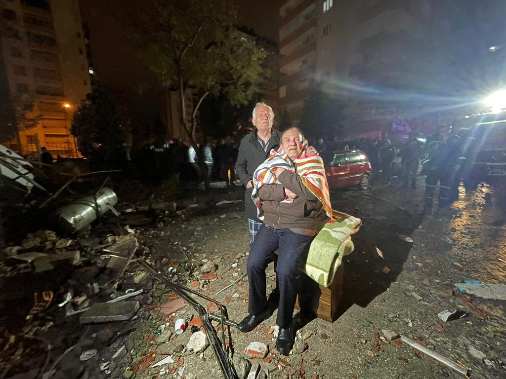 Residents look towards a destroyed building in Adana, Turkey. Picture: Getty Images