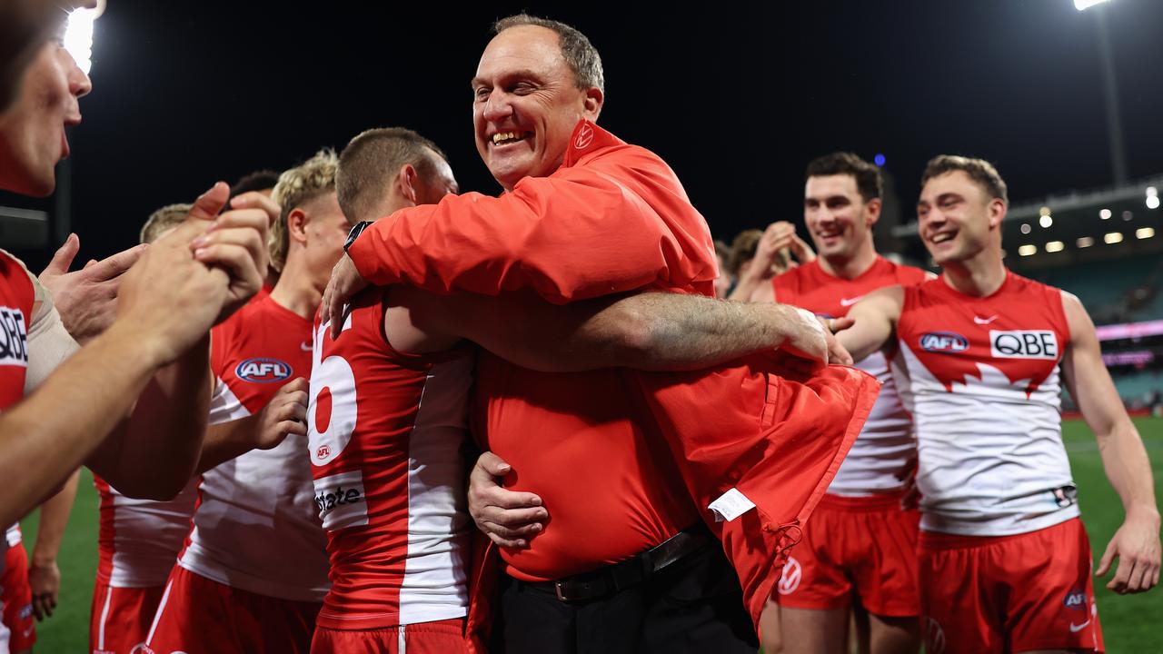 SYDNEY, AUSTRALIA - JULY 13: Swans head coach John Longmire celebrates with his team after his 300th match as coach and victory in the round 18 AFL match between Sydney Swans and Western Bulldogs at Sydney Cricket Ground, on July 13, 2023, in Sydney, Australia. (Photo by Cameron Spencer/Getty Images)
