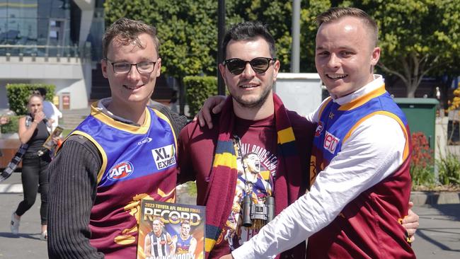 Visitors from Brisbane, Mitchell and Josh Bayley with Rob Kalaja hoping the Lions can pull off another grand final triumph over the Pies. Picture: NCA NewsWire / Valeriu Campan