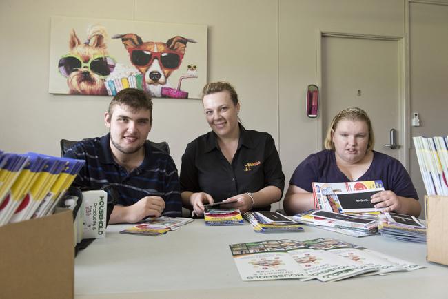 Rebecca Asgill (centre) helps Dan Hartfiel and Bec McDermott get pamphlets ready for delivery at Big Dog Services, Tuesday, March 14, 2017. Picture: Kevin Farmer